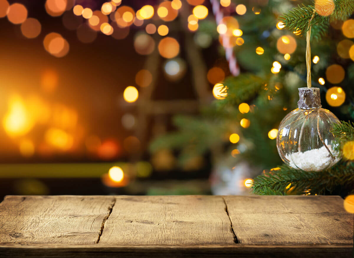 Christmas ball hanging on a Christmas tree surrounded by lights