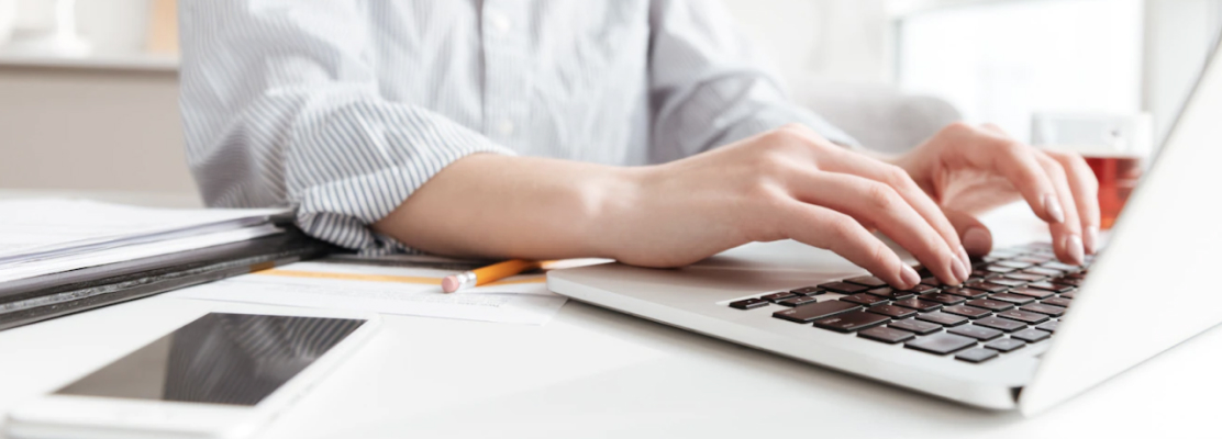 A woman is working on a laptop