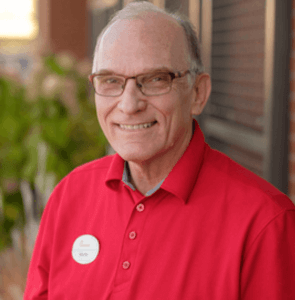 Smiling man in glasses and a red t-shirt