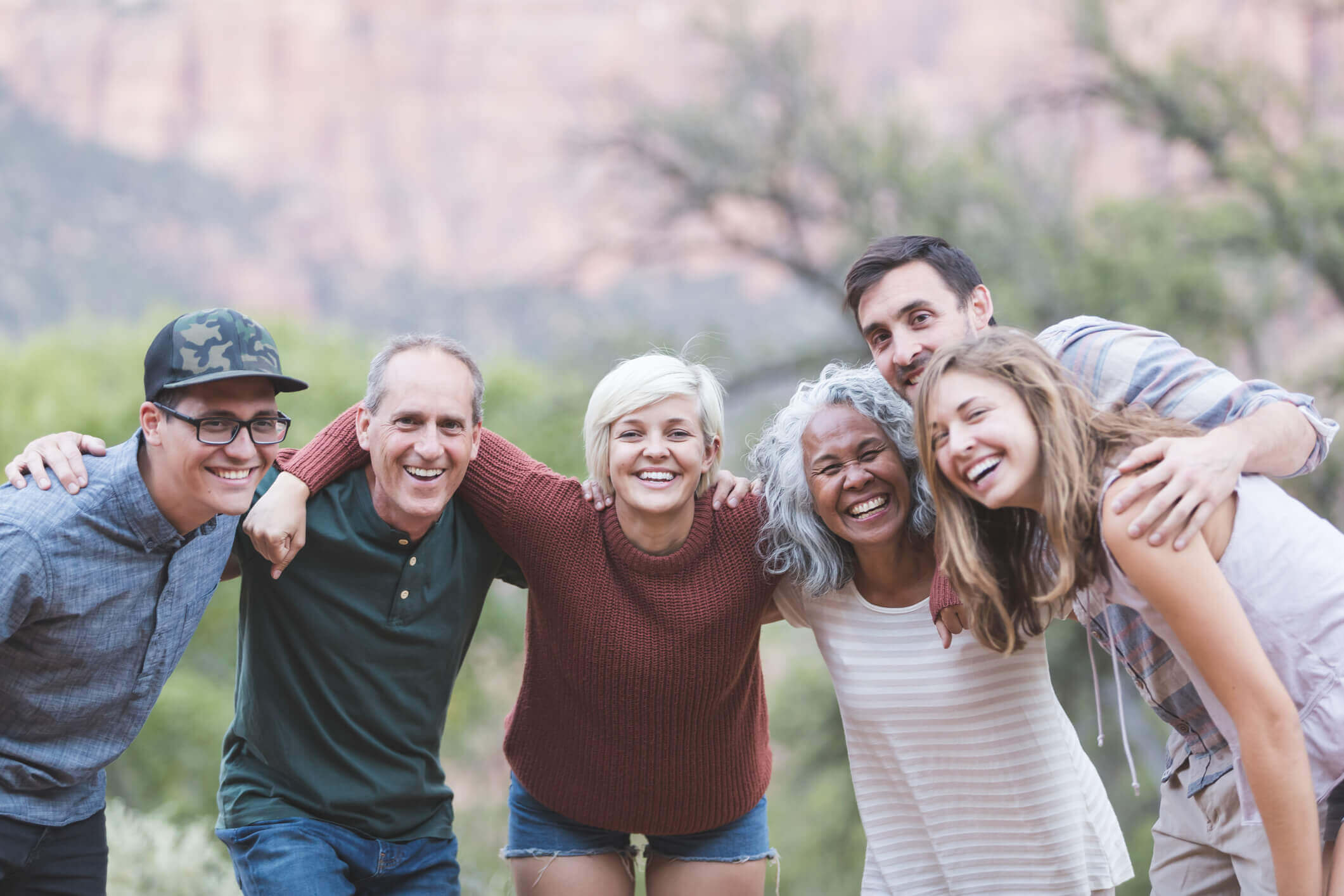 Multi-generational of friends posing together outside