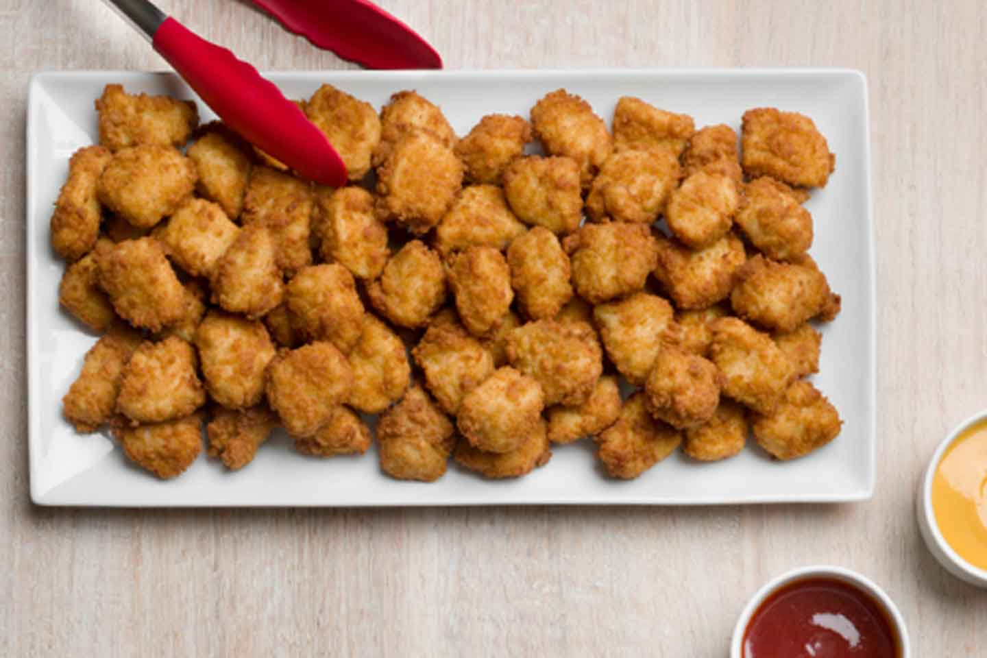 Chick-fil-A chicken nuggets on a plate with sauces