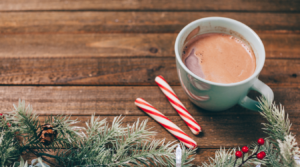 A hot chocolate with peppermint sticks on a table