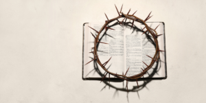 The crown of thorns laying on the open Bible