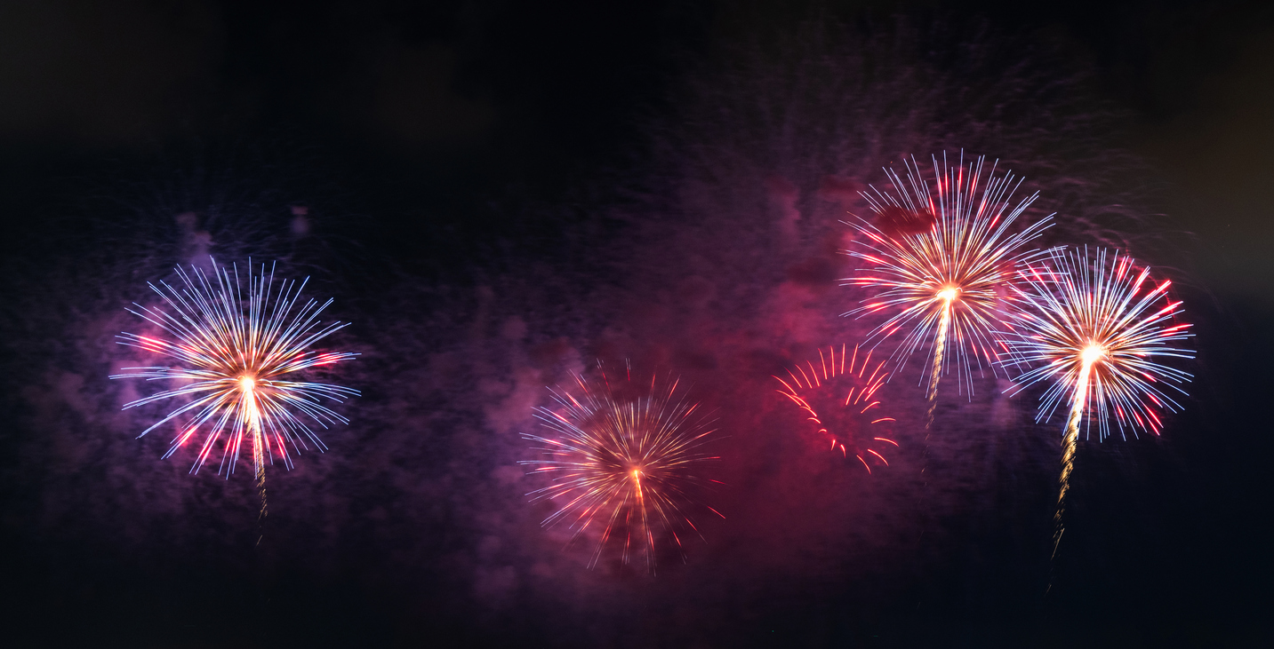 Beautiful fireworks display on dark sky background