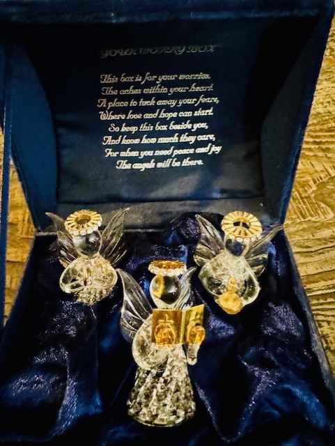 Three crystal angels in a box.