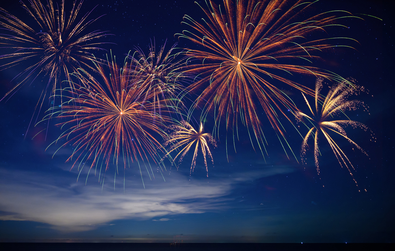 Stunning fireworks illuminate the night sky over the ocean, symbolizing celebration, hope, and the excitement of welcoming 2026 with bright new beginnings