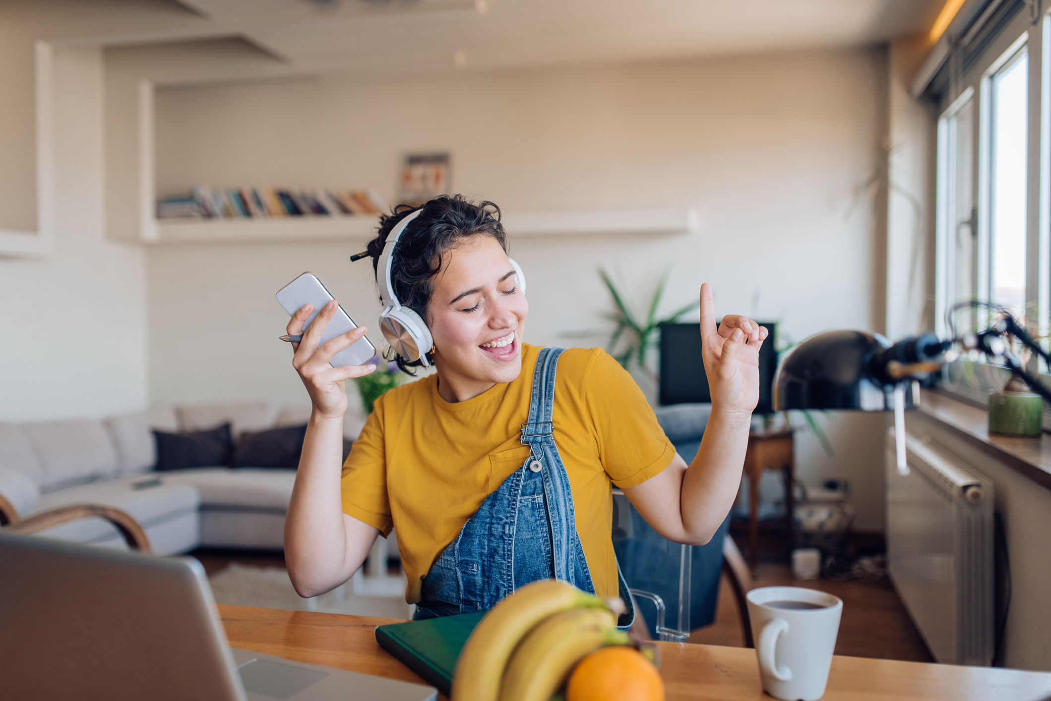 Young woman listening to the music and enjoying at home after work.